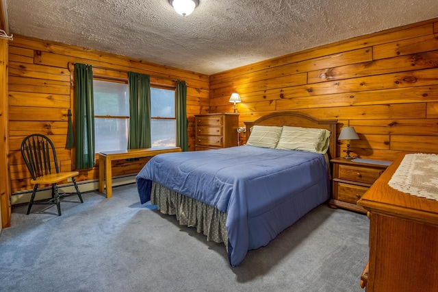 carpeted bedroom featuring wood walls, a textured ceiling, and a baseboard radiator