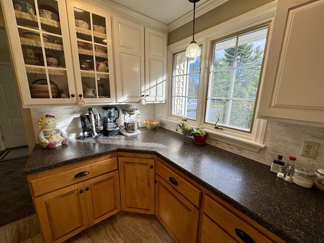 12 Hycrest Ln, Old Town, ME 04468 - kitchen featuring pendant lighting, tasteful backsplash, glass insert cabinets, white cabinets, and ornamental molding