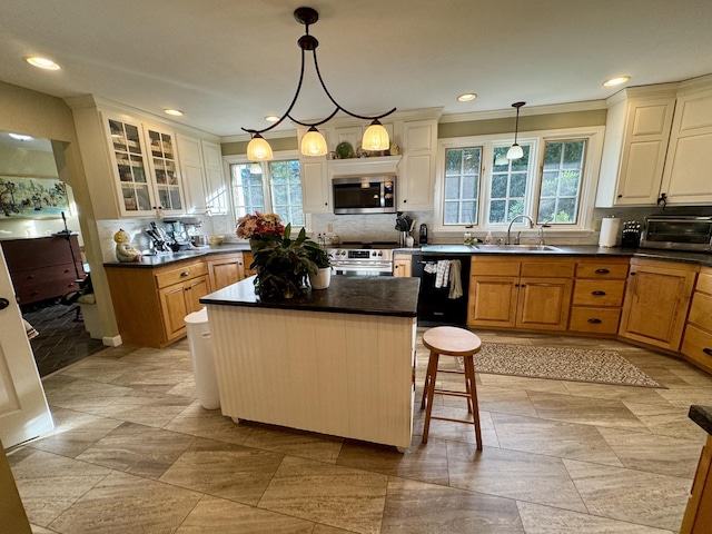 12 Hycrest Ln, Old Town, ME 04468 - kitchen with a healthy amount of sunlight, stainless steel appliances, decorative backsplash, a sink, and dark countertops