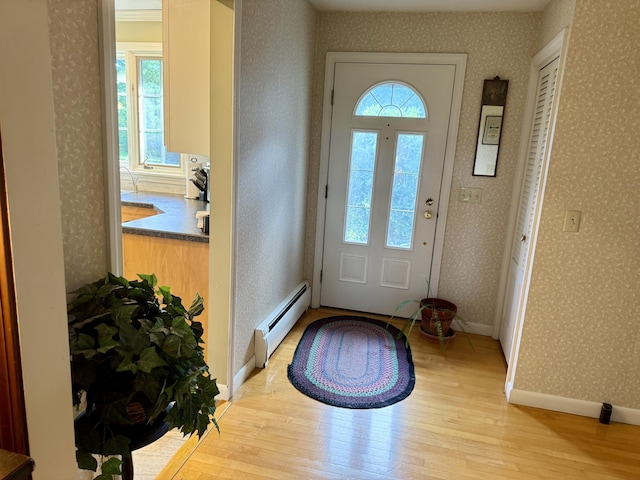 12 Hycrest Ln, Old Town, ME 04468 - entryway featuring baseboards, wallpapered walls, light wood-type flooring, and baseboard heating