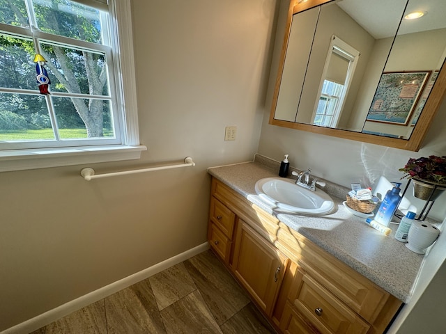 12 Hycrest Ln, Old Town, ME 04468 - bathroom with baseboards, wood finished floors, and vanity