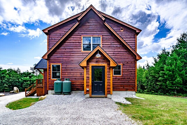 log-style house with a front lawn