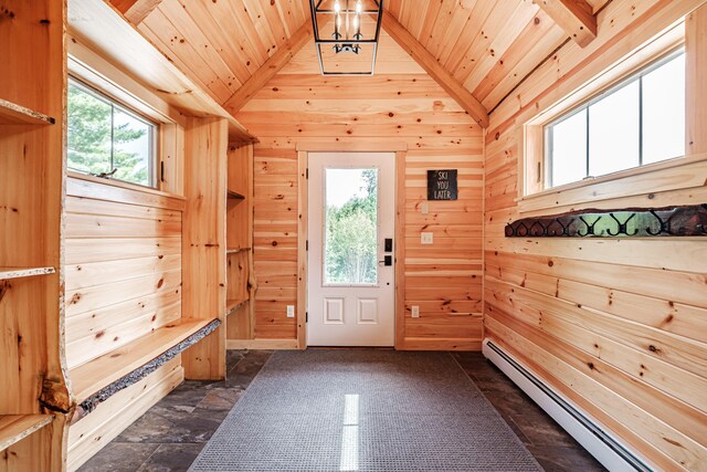 mudroom featuring wood walls, a healthy amount of sunlight, and a baseboard radiator