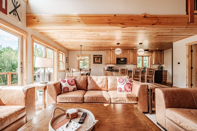 living room featuring a notable chandelier and wooden ceiling