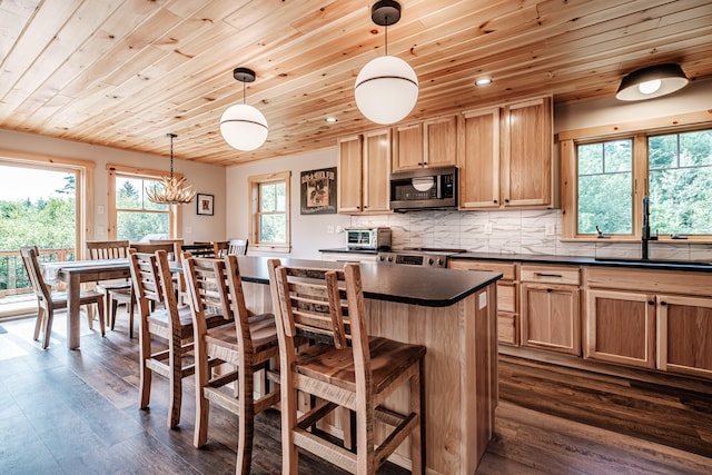 kitchen featuring plenty of natural light, sink, hanging light fixtures, and appliances with stainless steel finishes