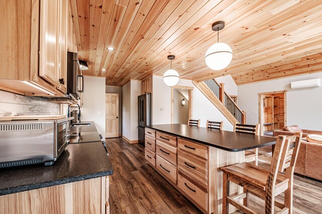 kitchen featuring light brown cabinetry, appliances with stainless steel finishes, wood ceiling, dark wood-type flooring, and pendant lighting