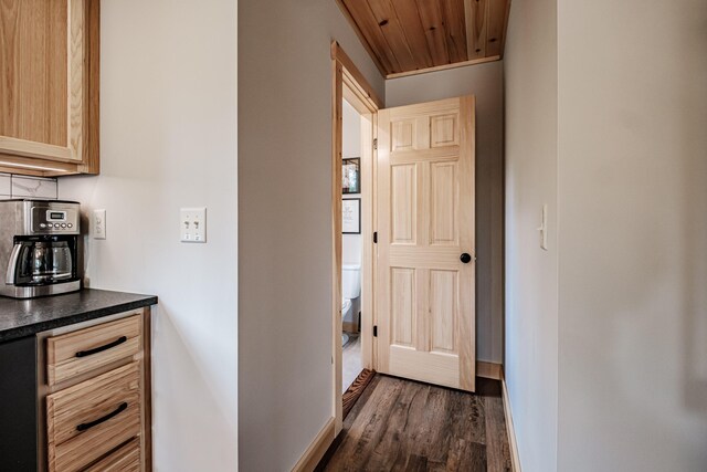 corridor featuring wood ceiling and dark wood-type flooring