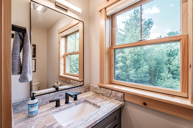 bathroom featuring vanity and toilet