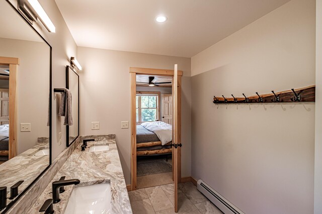 bathroom featuring baseboard heating, ceiling fan, and vanity