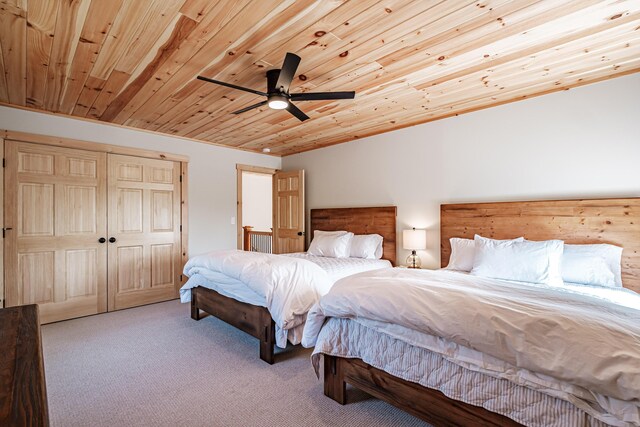 bedroom featuring light carpet, a closet, ceiling fan, and wooden ceiling