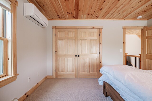 unfurnished bedroom featuring a wall mounted air conditioner, light colored carpet, a closet, and wood ceiling