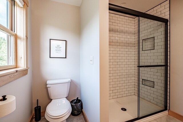 bathroom featuring toilet, tile patterned flooring, and walk in shower