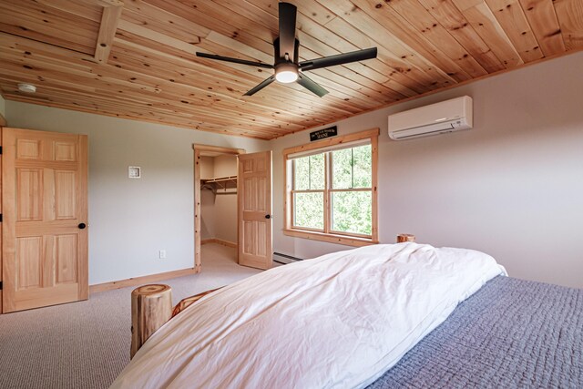 bedroom featuring light carpet, an AC wall unit, ceiling fan, a spacious closet, and a baseboard radiator