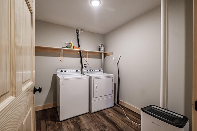 clothes washing area featuring washing machine and dryer and dark wood-type flooring