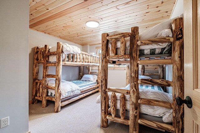 bedroom featuring wooden ceiling and carpet floors