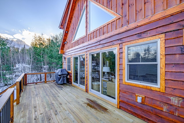 wooden deck with a grill