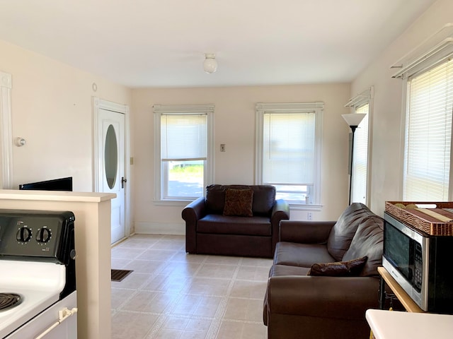 tiled living room with a healthy amount of sunlight