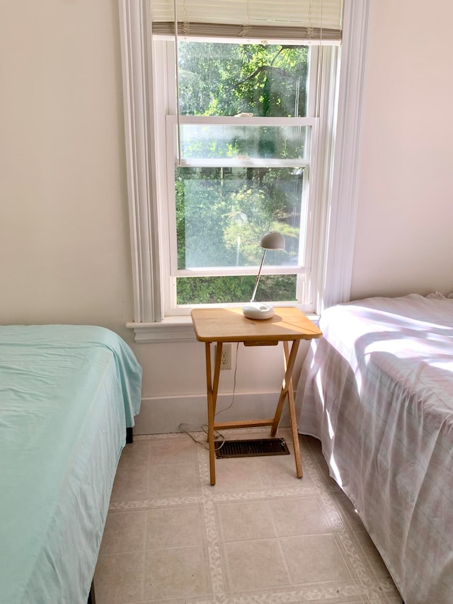 tiled bedroom with multiple windows