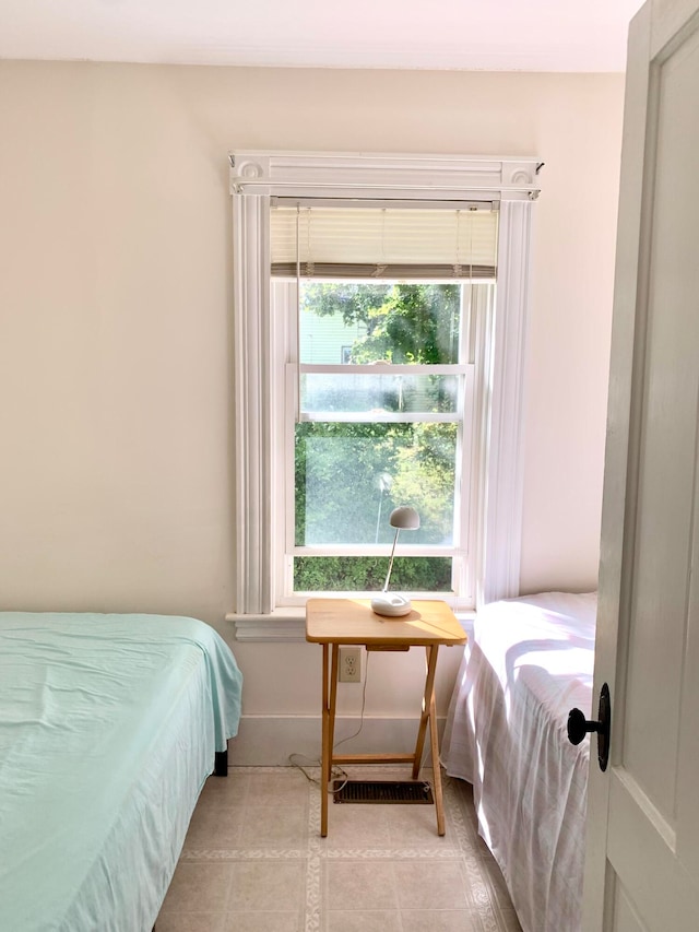 bedroom featuring light tile patterned floors