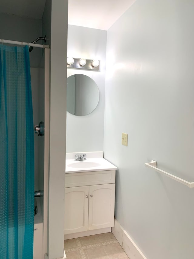 bathroom with shower / bath combo, vanity, and tile patterned flooring