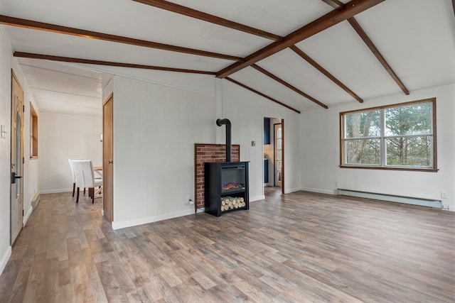 living room featuring hardwood / wood-style flooring, a wood stove, baseboard heating, and vaulted ceiling with beams