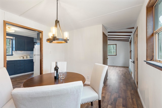 dining area featuring dark hardwood / wood-style floors and vaulted ceiling