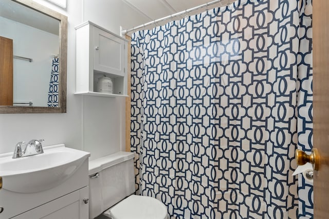 bathroom featuring vanity, toilet, and a shower with shower curtain