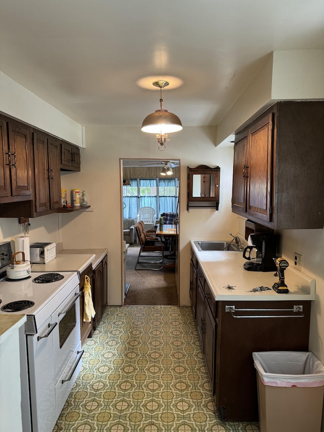 kitchen with electric range, light tile patterned floors, hanging light fixtures, and dark brown cabinetry