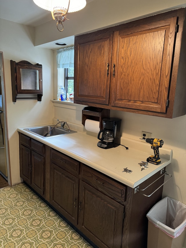 kitchen with light tile patterned floors and sink