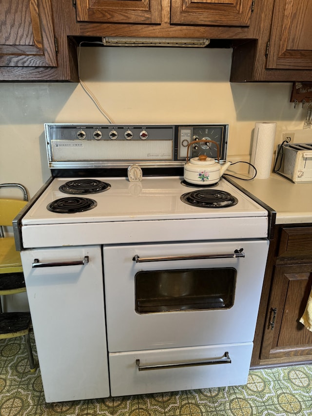 kitchen featuring tile patterned floors and electric stove