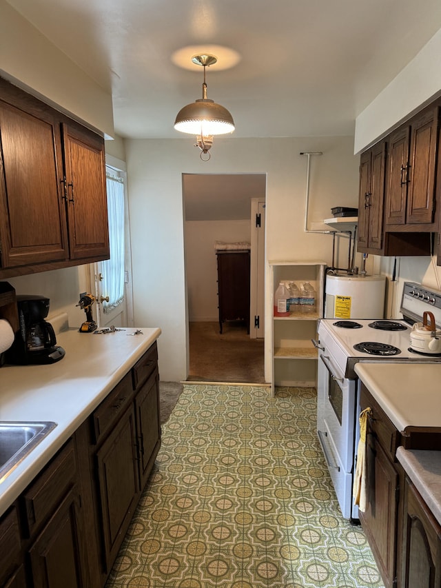 kitchen featuring light tile patterned floors, dark brown cabinets, white electric stove, and hanging light fixtures