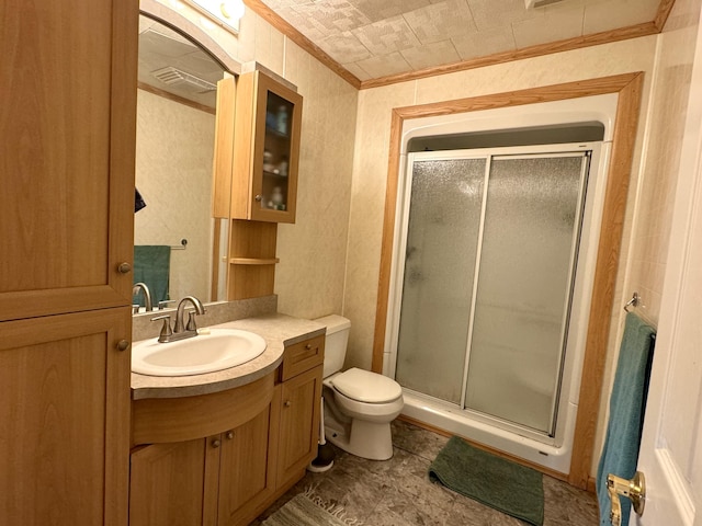 bathroom featuring crown molding, a shower stall, toilet, and vanity