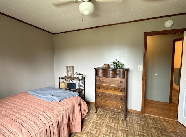 bedroom with ceiling fan, parquet floors, baseboards, and crown molding