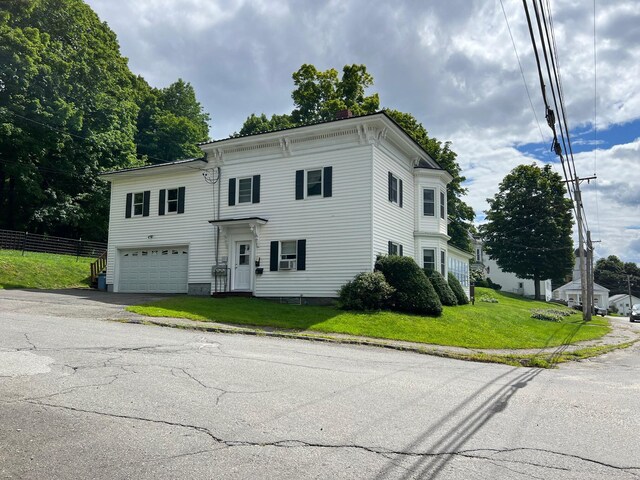 view of front of home with a front yard and a garage