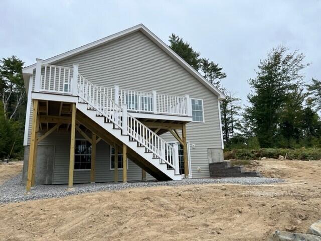 back of house featuring a wooden deck