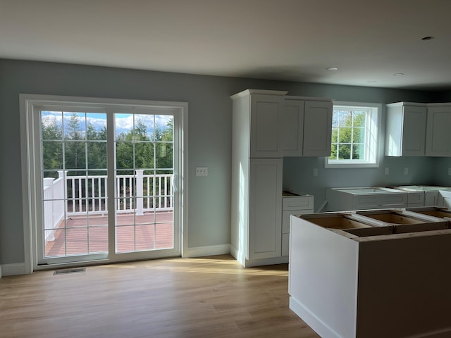 kitchen featuring white cabinetry and light wood-type flooring