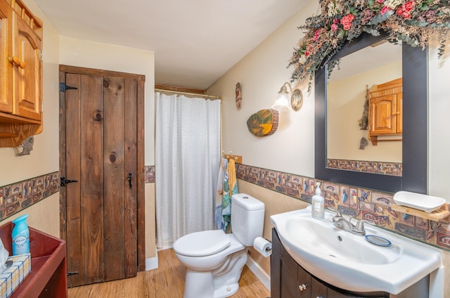 65 Harmony Hills Rd, Readfield, ME 04355 - full bathroom with curtained shower, toilet, wood finished floors, and vanity