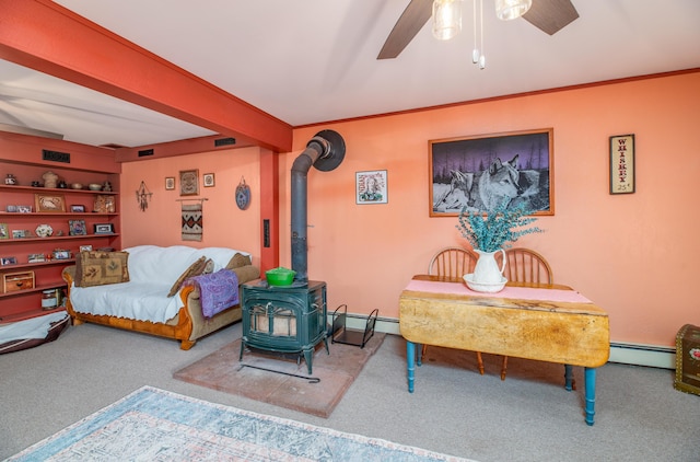 65 Harmony Hills Rd, Readfield, ME 04355 - living room featuring crown molding, ceiling fan, carpet, a wood stove, and a baseboard radiator