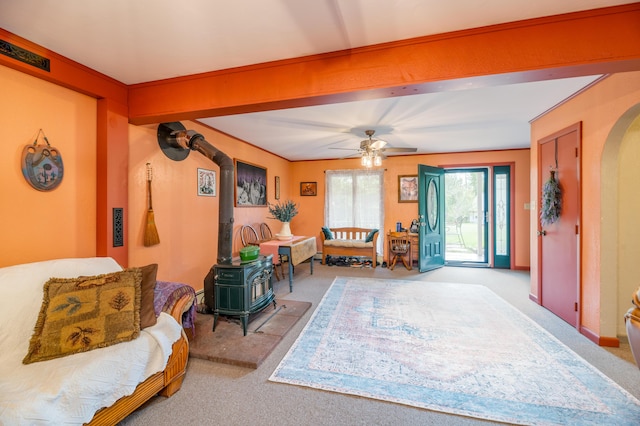 65 Harmony Hills Rd, Readfield, ME 04355 - interior space with arched walkways, a wood stove, a ceiling fan, and carpet floors