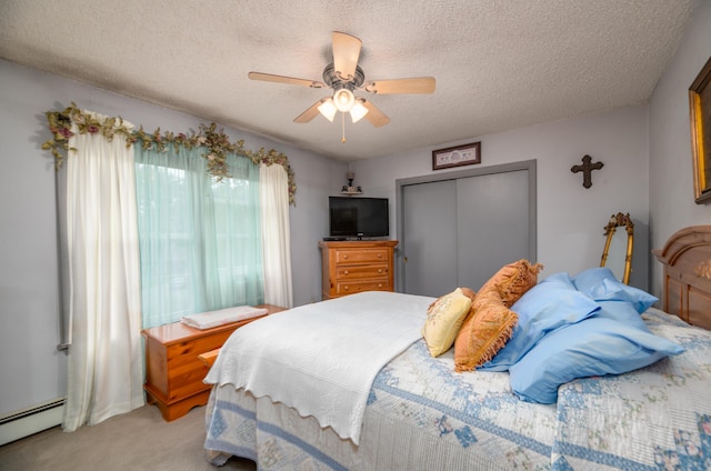 65 Harmony Hills Rd, Readfield, ME 04355 - bedroom with a ceiling fan, a closet, a textured ceiling, light carpet, and baseboard heating
