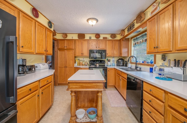 65 Harmony Hills Rd, Readfield, ME 04355 - kitchen with black appliances, light countertops, and a sink