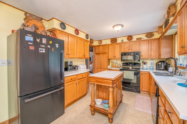 65 Harmony Hills Rd, Readfield, ME 04355 - kitchen featuring a sink, a textured ceiling, black appliances, and light countertops