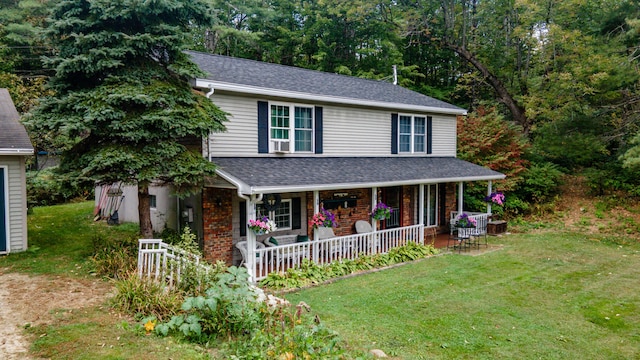 65 Harmony Hills Rd, Readfield, ME 04355 - traditional-style home with brick siding, roof with shingles, covered porch, and a front lawn