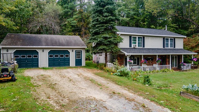 65 Harmony Hills Rd, Readfield, ME 04355 - view of front of home featuring a porch, a front yard, a garage, an outbuilding, and driveway
