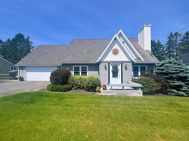 view of front of property with a front lawn and a garage