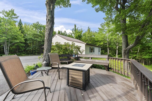 wooden terrace with a fire pit