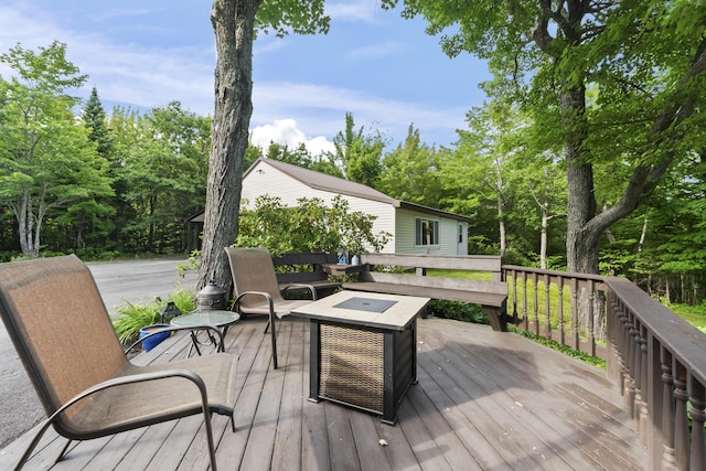 wooden deck with a fire pit