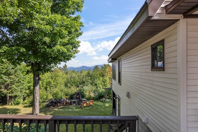 view of property exterior featuring a mountain view and a lawn