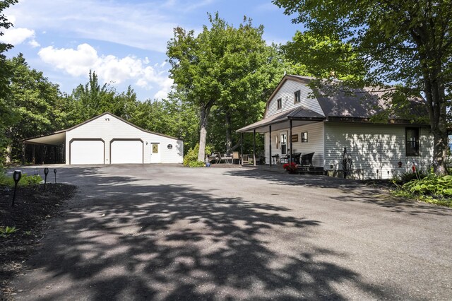 view of side of home featuring a garage and an outdoor structure