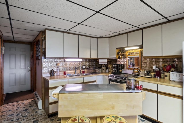 kitchen featuring light countertops, range with electric cooktop, and white cabinetry